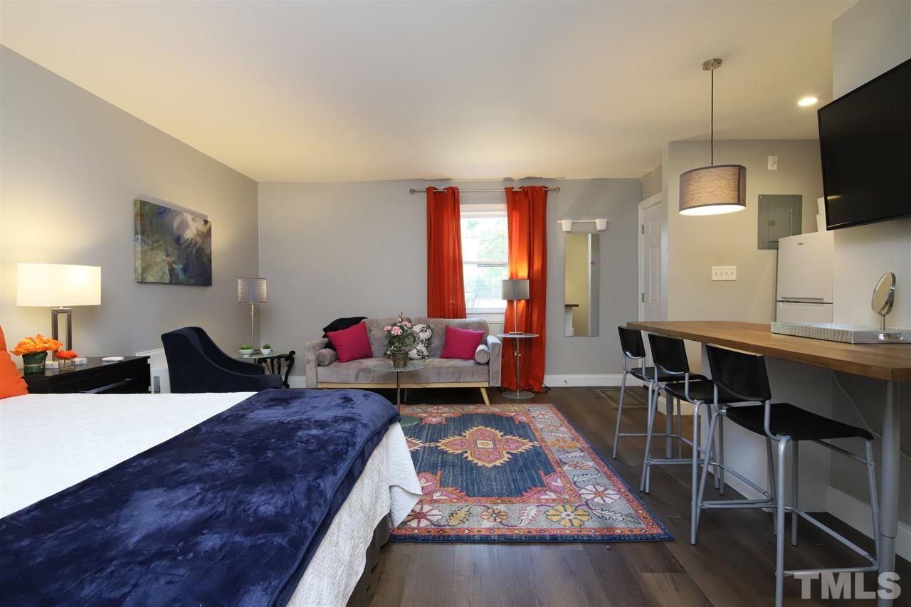 815 Clay Street Raleigh, NC 27605 - Photo 6 of 30 a living room with furniture and a flat screen tv