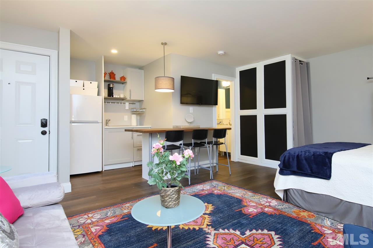 815 Clay Street Raleigh, NC 27605 - Photo 7 of 30 a living room with furniture potted plant and kitchen view