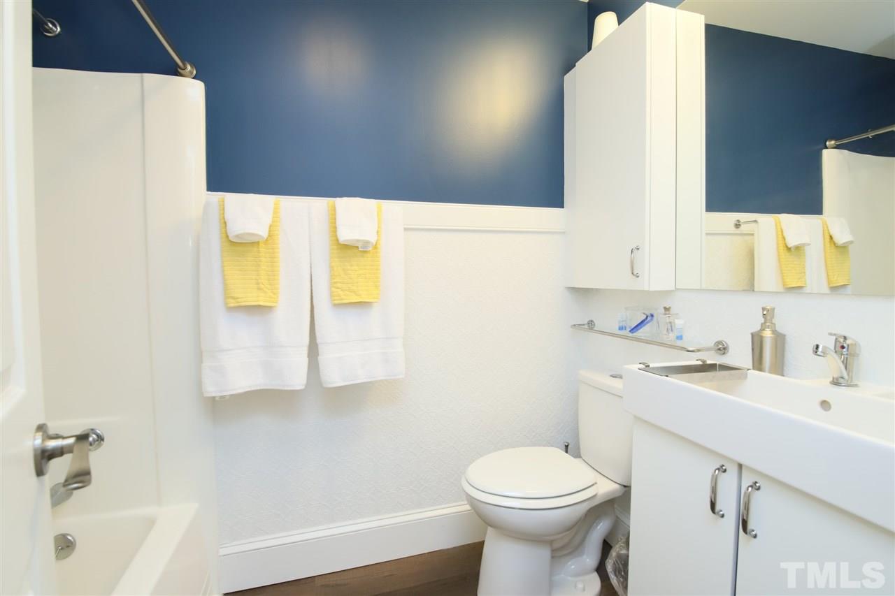815 Clay Street Raleigh, NC 27605 - Photo 10 of 30 a bathroom with a sink a toilet and tub