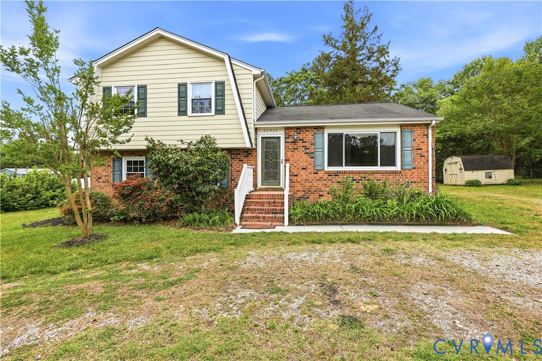 Two-story residence featuring brick and siding fac