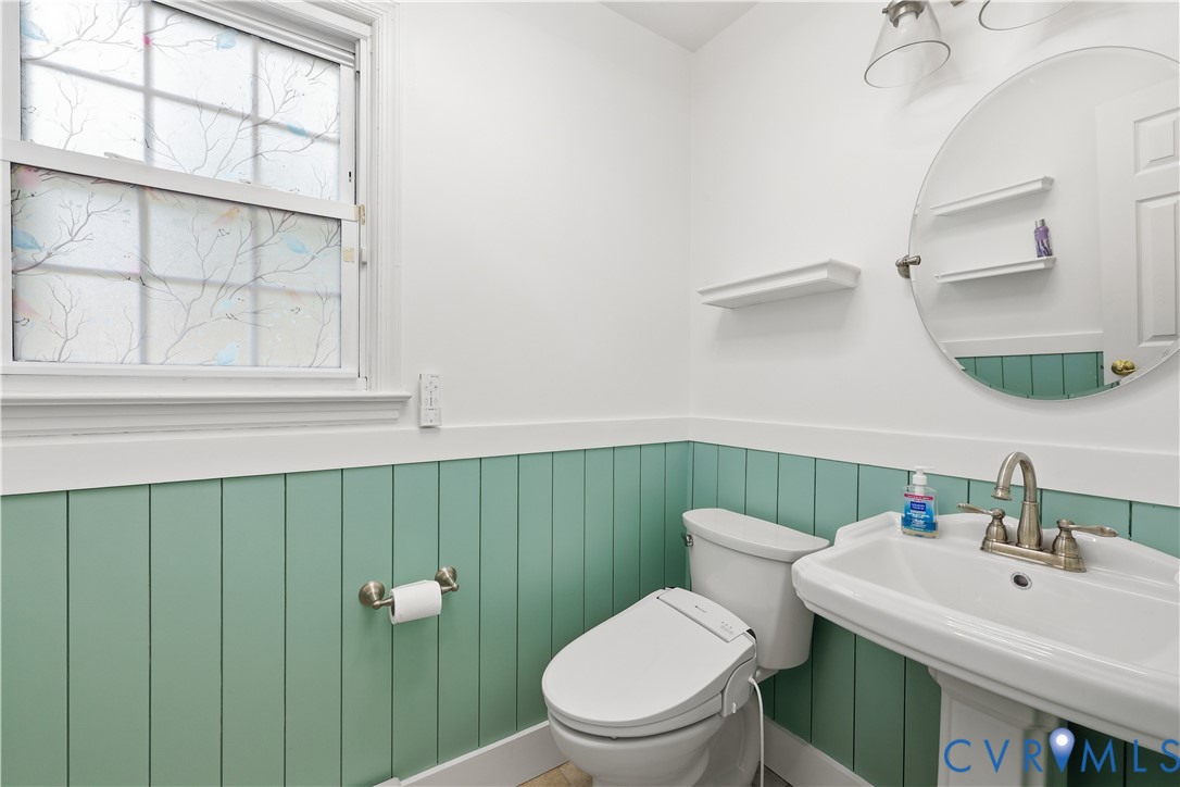22925 River Road Petersburg, VA 23803 - Photo 12 of 27 Bathroom featuring a pedestal sink, round wall mir
