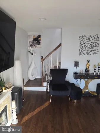 a living room with furniture a dining table and a fireplace