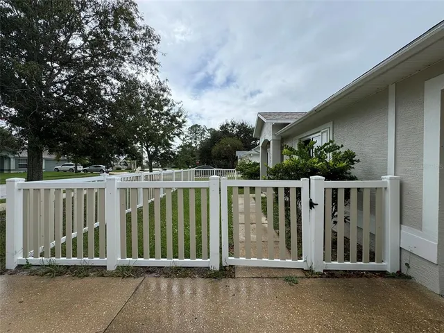 a view of a house with a wooden fence