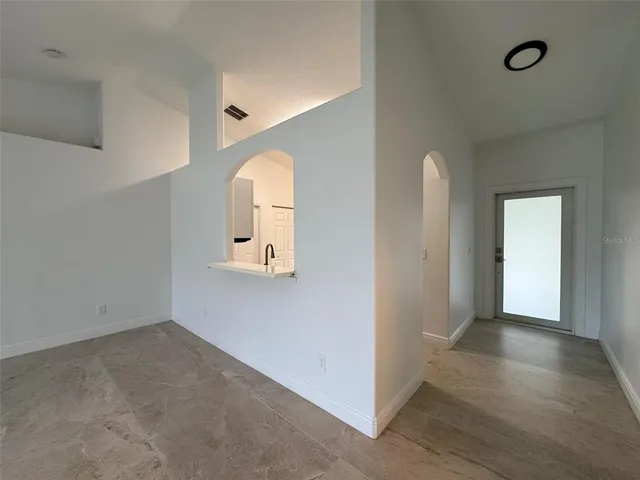 wooden floor in a hall with a window