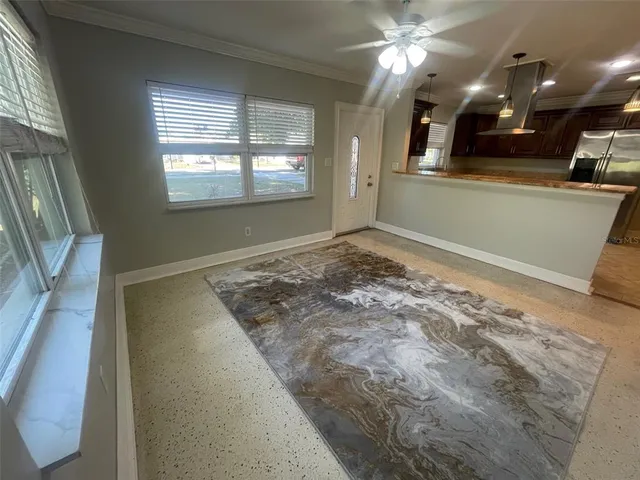 a view of a livingroom with a ceiling fan and window