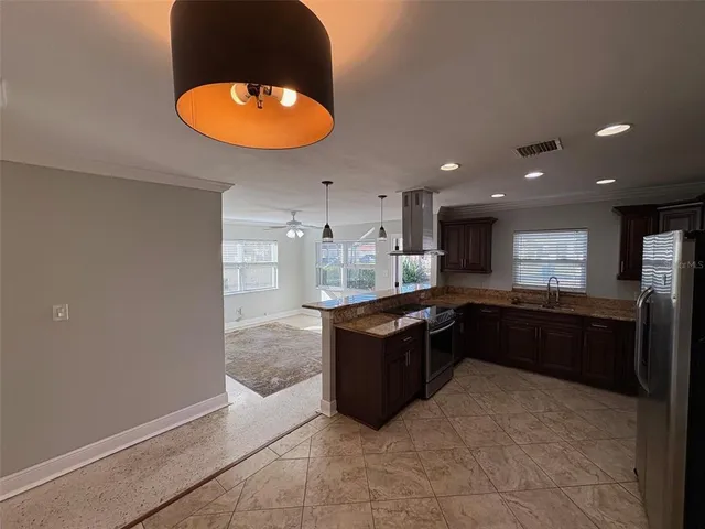 a kitchen with stainless steel appliances granite countertop a stove and a refrigerator