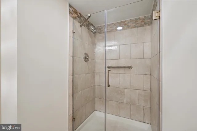 a bathroom with a glass shower door