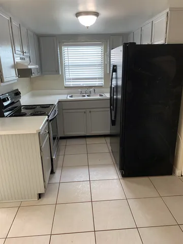 a kitchen with a cabinets and a stove top oven