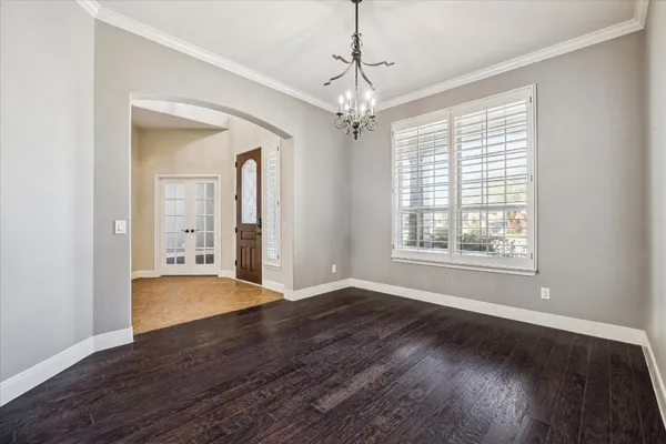 a kitchen with stainless steel appliances granite countertop a sink a stove and a wooden floor