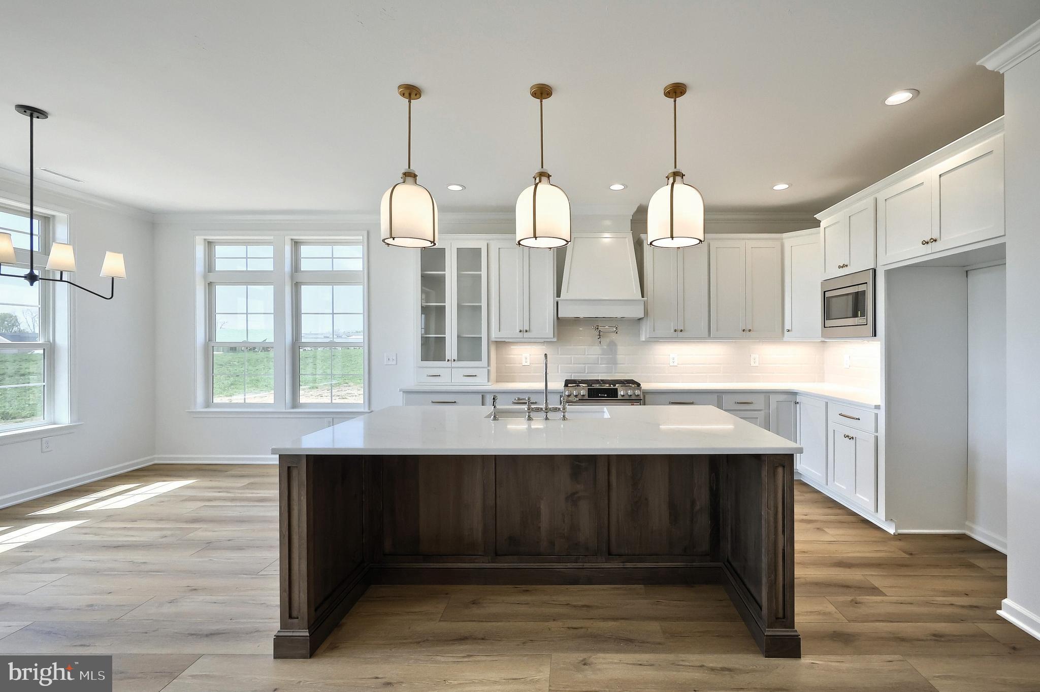 567 Lumber Street Littlestown, PA 17340 - Photo 43 of 62 a kitchen with kitchen island granite countertop a sink cabinets and stainless steel appliances