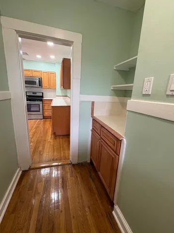 a view of kitchen and wooden floor
