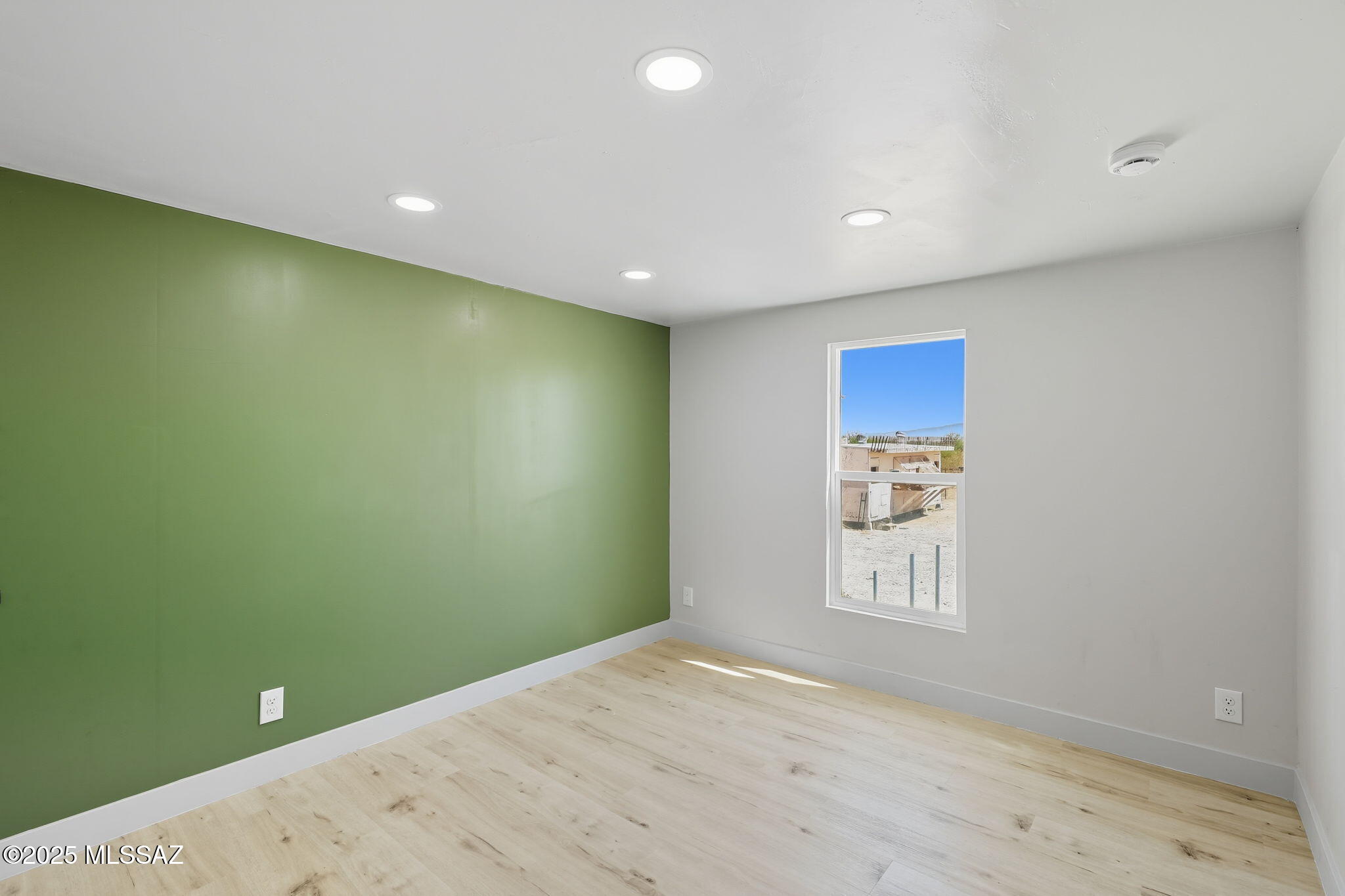 8790 North Trico Road Marana, AZ 85653 - Photo 20 of 35 a view of a room with a wooden floor and a window