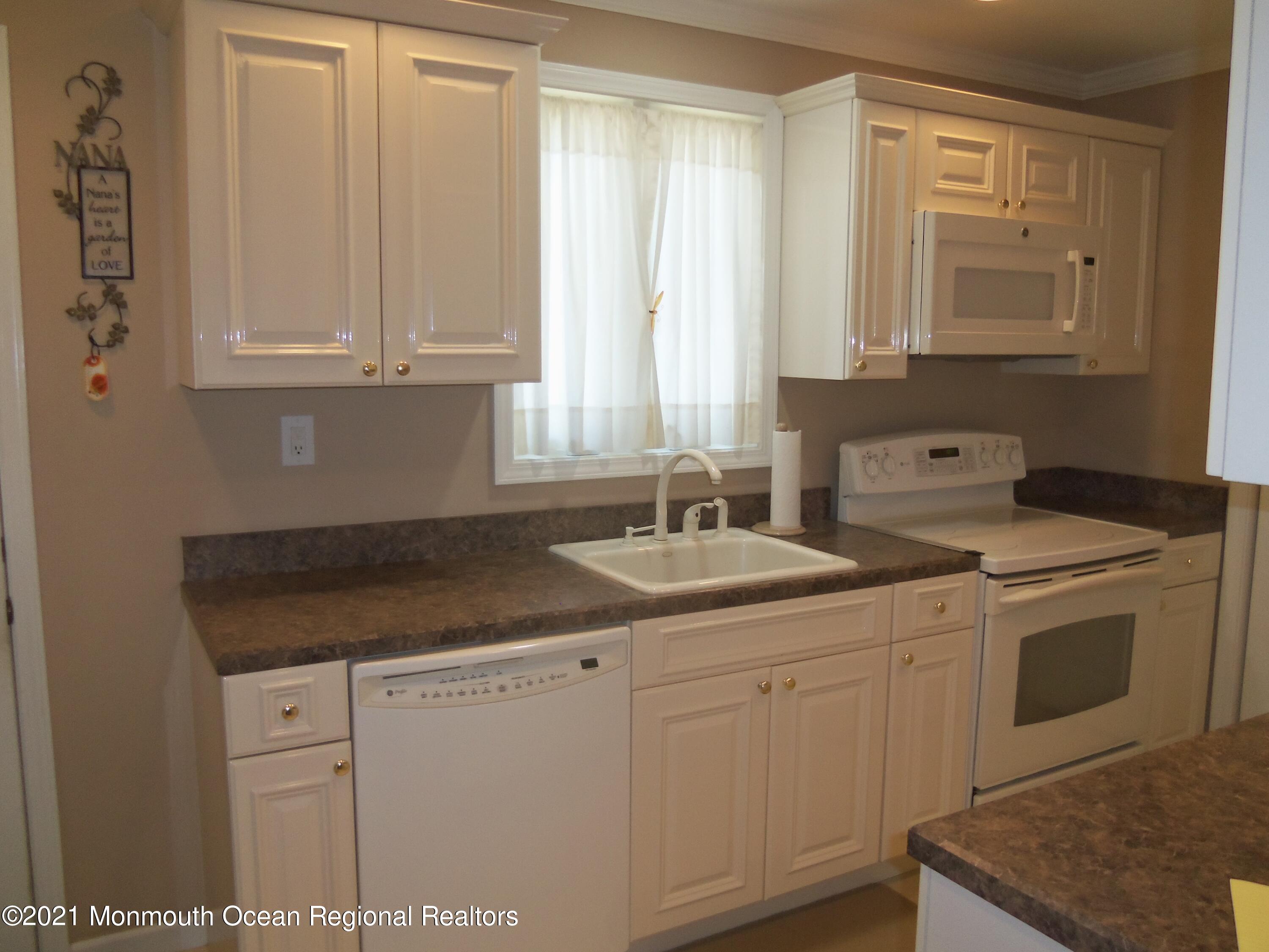 338 Pitcairn Road Brick, NJ 08723 - Photo 1 of 24 a kitchen with white cabinets and sink