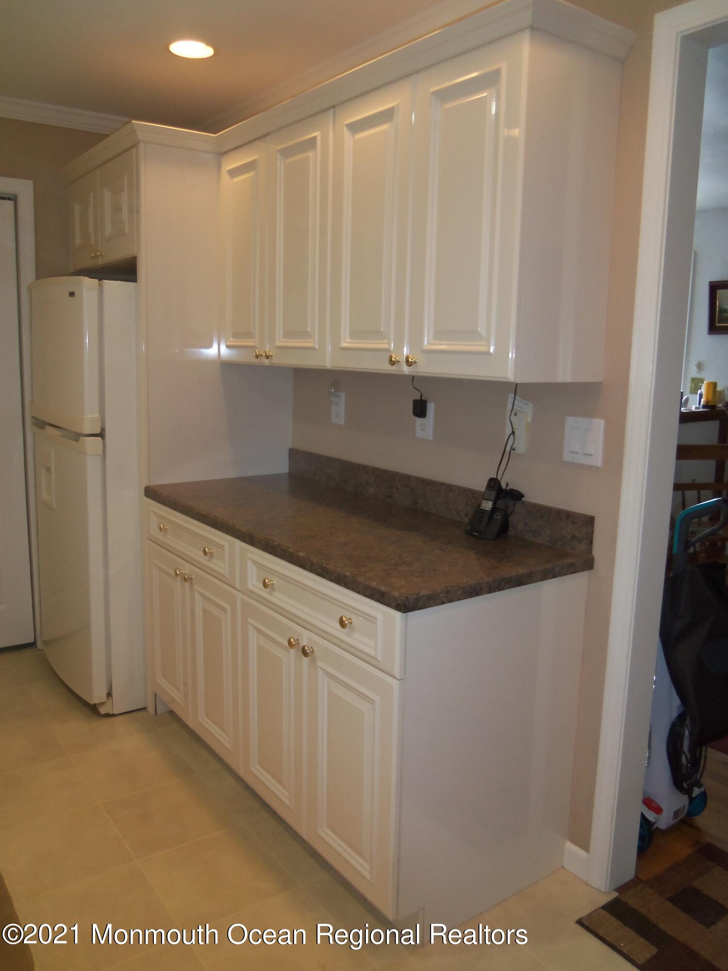 338 Pitcairn Road Brick, NJ 08723 - Photo 2 of 24 a kitchen with a sink and cabinets