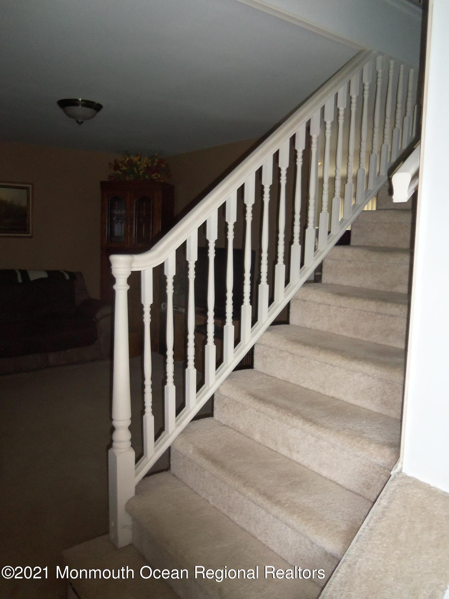 338 Pitcairn Road Brick, NJ 08723 - Photo 12 of 24 a view of staircase with railing and a rug