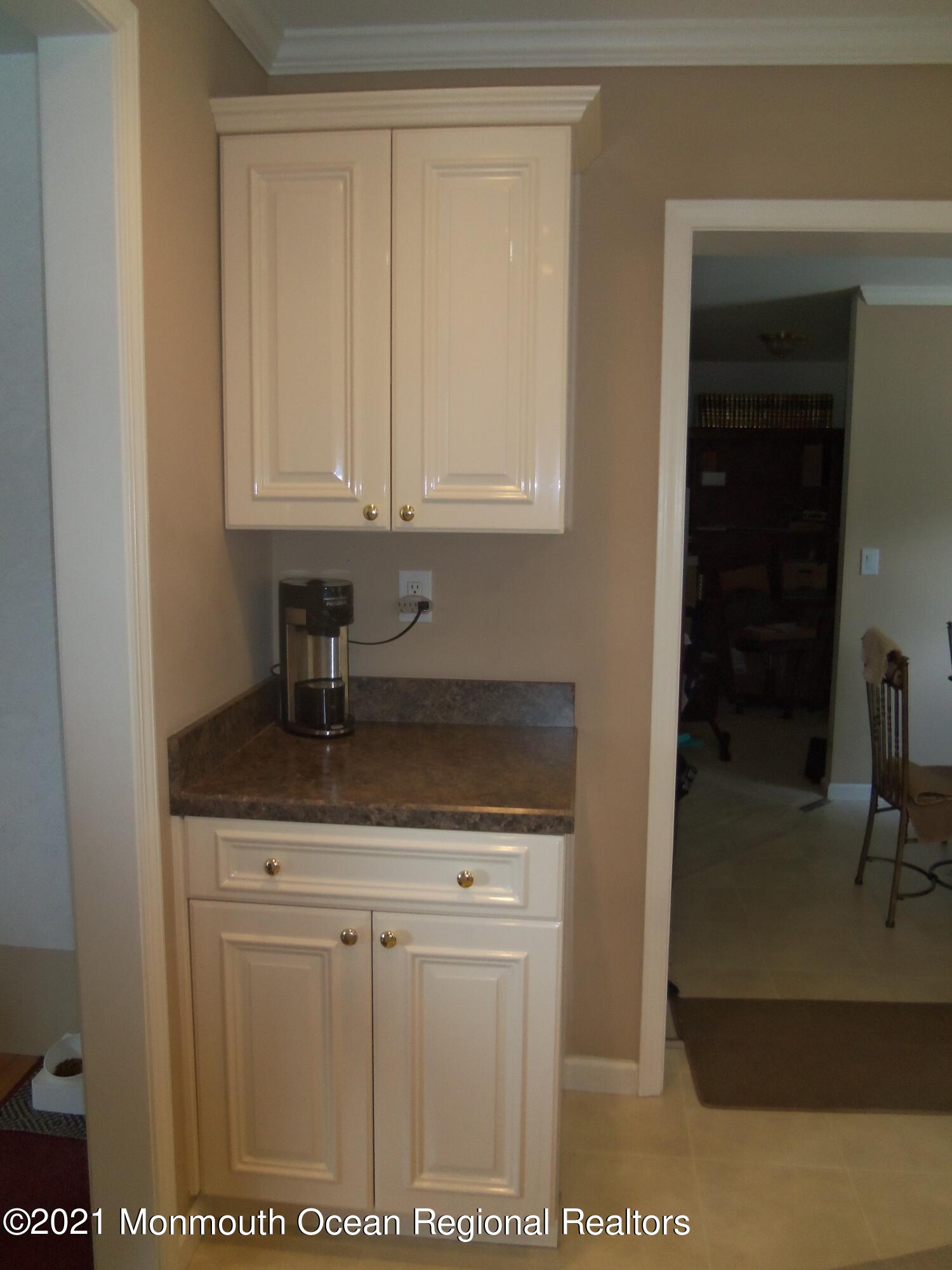 338 Pitcairn Road Brick, NJ 08723 - Photo 3 of 24 a kitchen with granite countertop a sink and cabinets