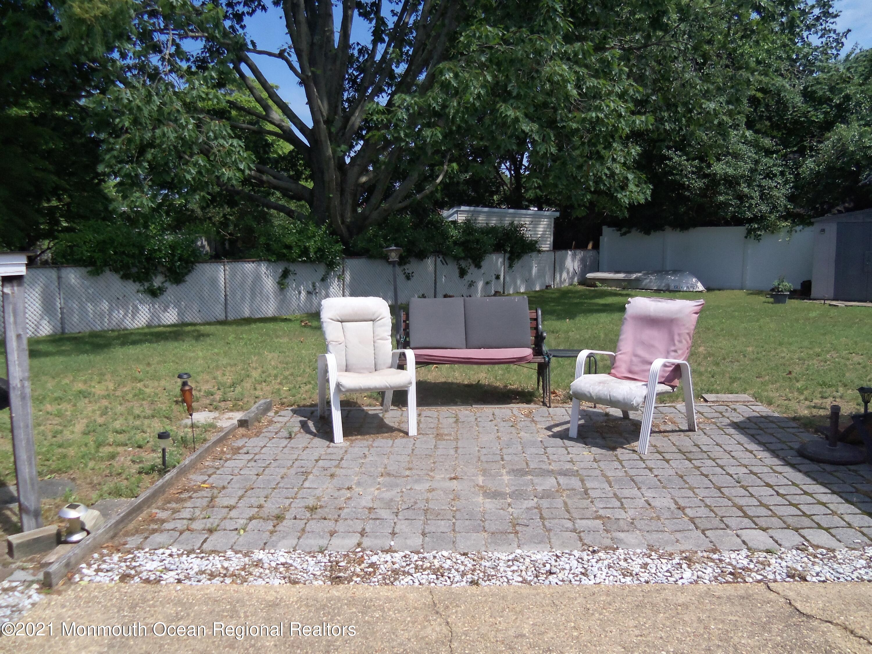 338 Pitcairn Road Brick, NJ 08723 - Photo 23 of 24 a backyard of a house with outdoor seating