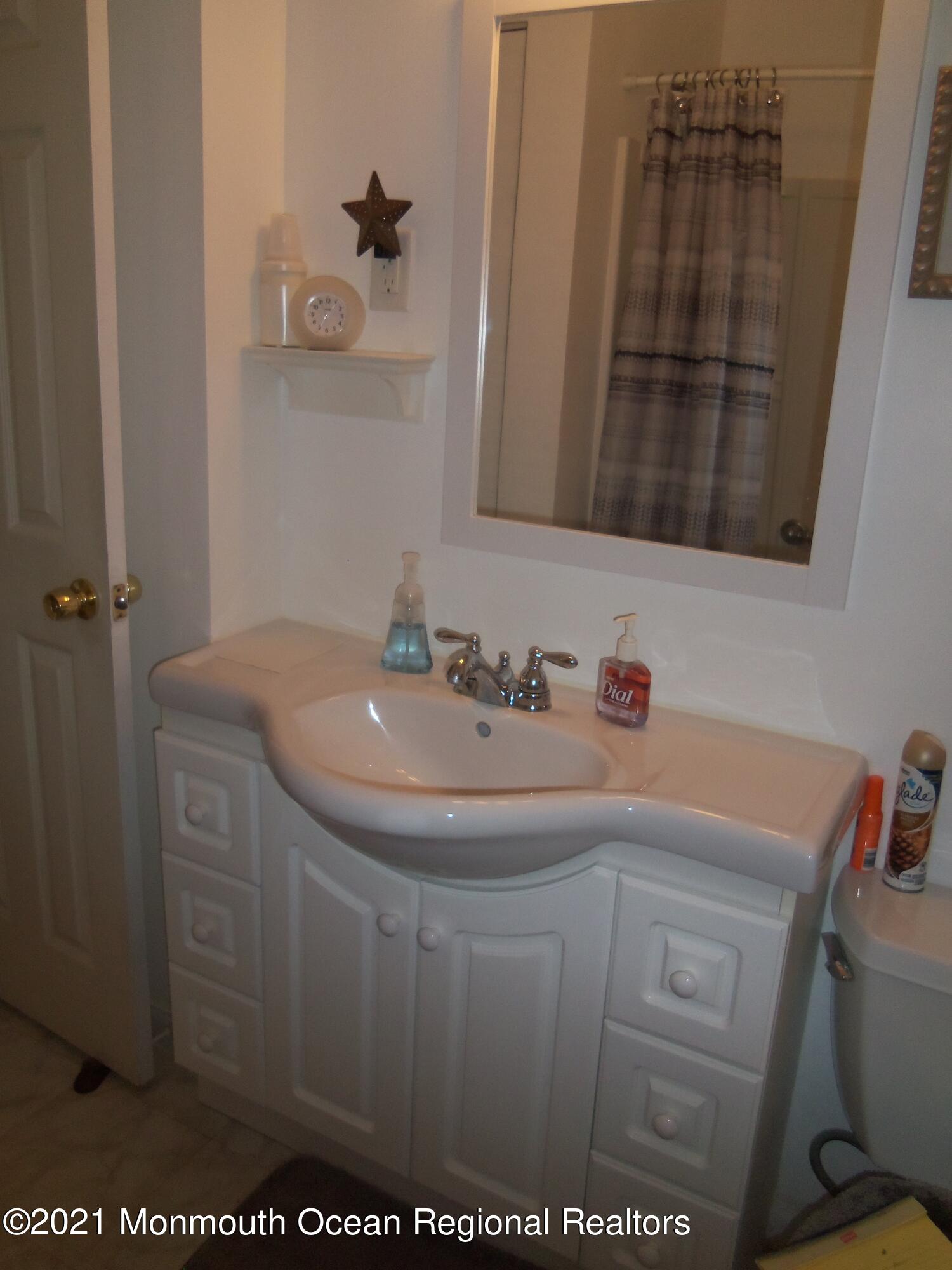 338 Pitcairn Road Brick, NJ 08723 - Photo 10 of 24 a bathroom with a sink and a mirror