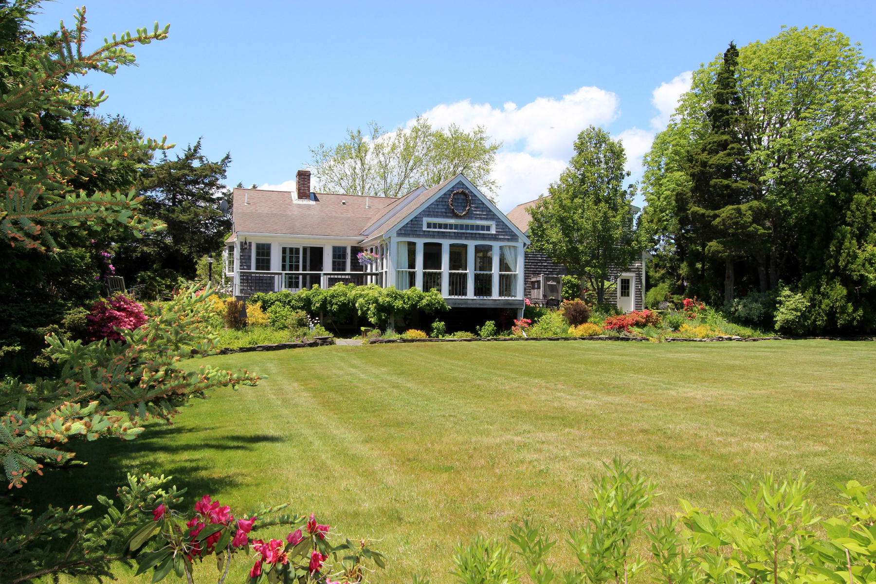 176 Gorham Road Harwich Port, MA 02646 - Photo 3 of 36 a front view of a house with a big yard and potted plants
