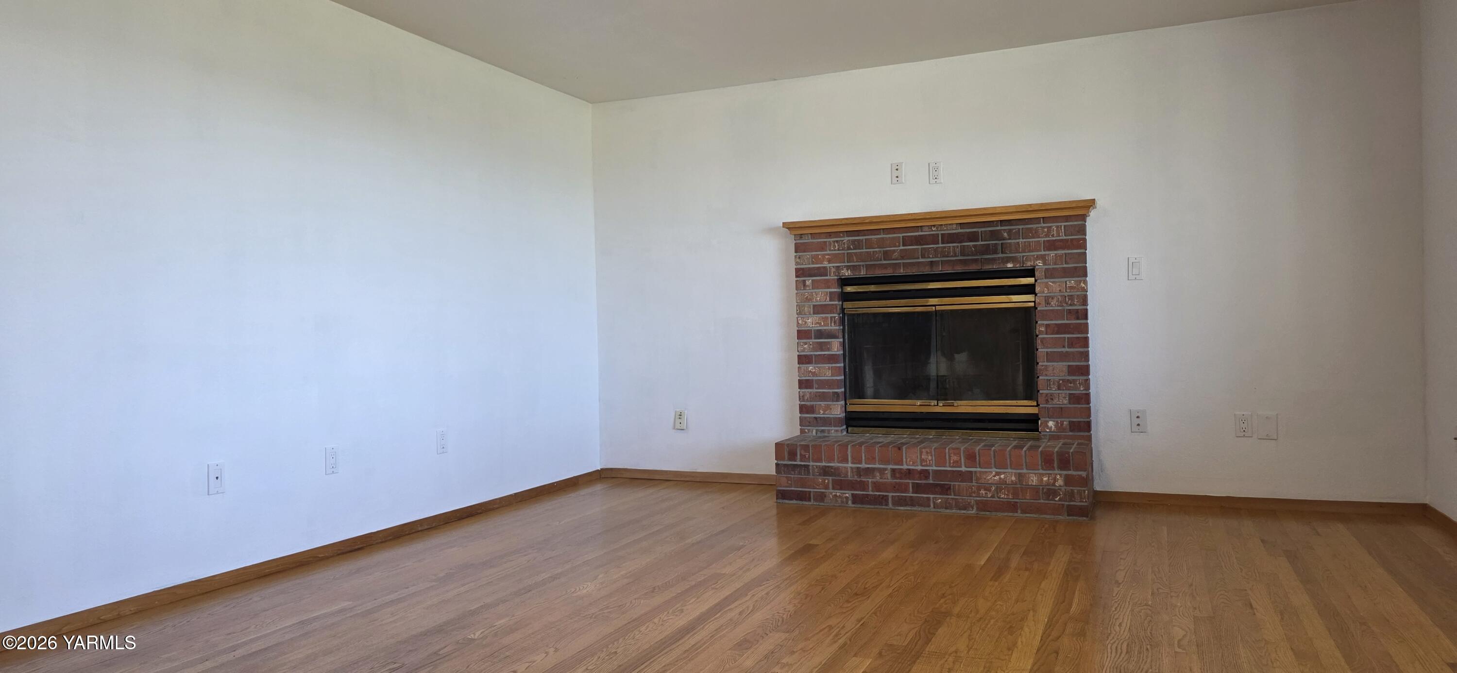 8601 Scenic Drive Yakima, WA 98908 - Photo 28 of 52 a view of an empty room with wooden floor fridge and a window
