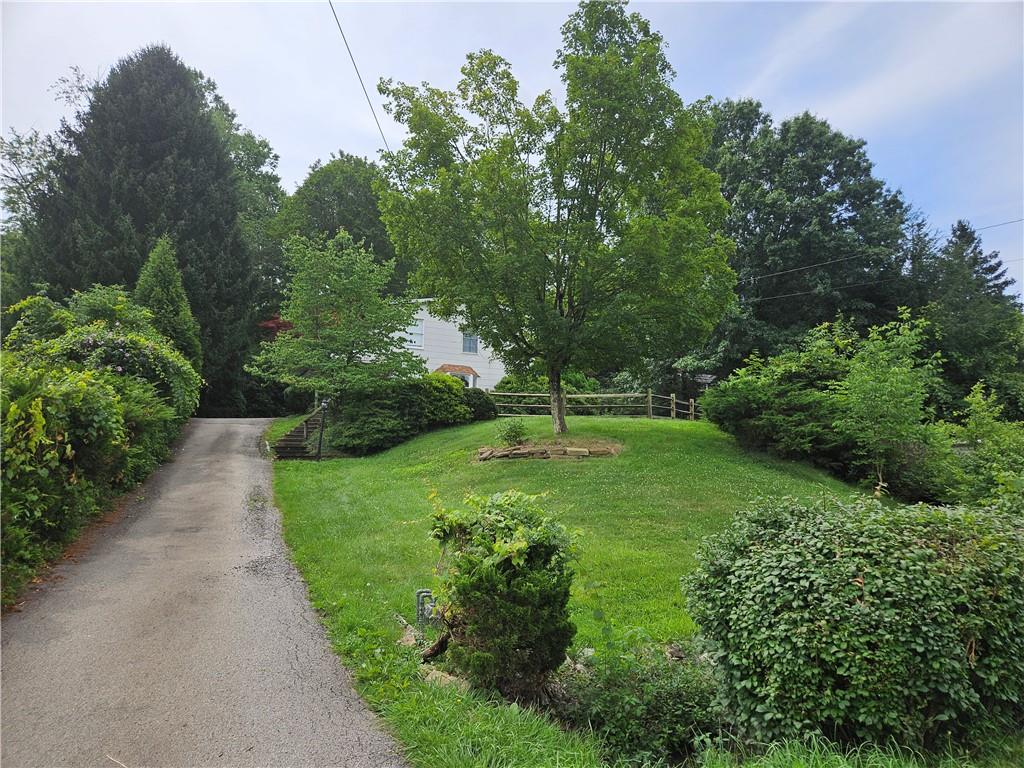 451 Buttermilk Hollow Road Irwin, PA 15642 - Photo 1 of 35 a view of a garden with large trees