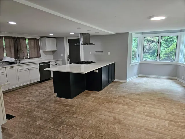 a kitchen with cabinets and stainless steel appliances