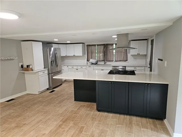 a stove top oven sitting inside of a kitchen