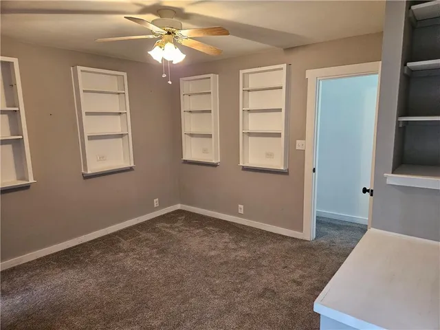 a bathroom with a toilet and a window