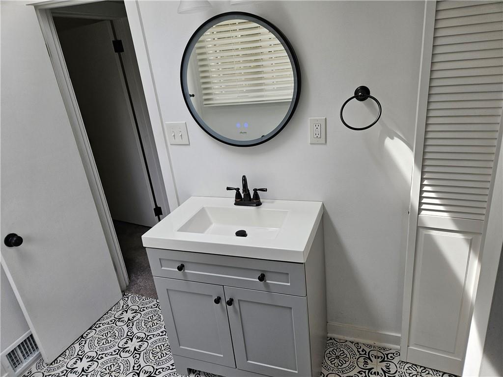 451 Buttermilk Hollow Road Irwin, PA 15642 - Photo 28 of 35 a bathroom with a sink and mirror