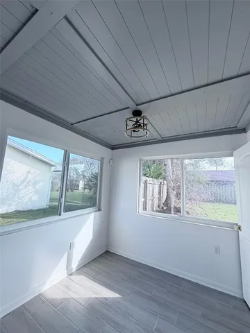 a bedroom with a bed and a large mirror on the dresser