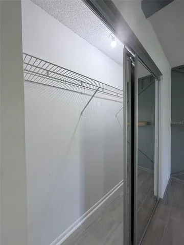 a bathroom with a sink a toilet a mirror and shower