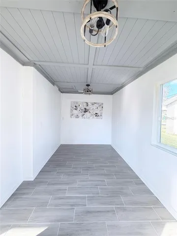 a kitchen with a refrigerator and wooden floor