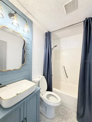 a view of a room that has a door and a chair