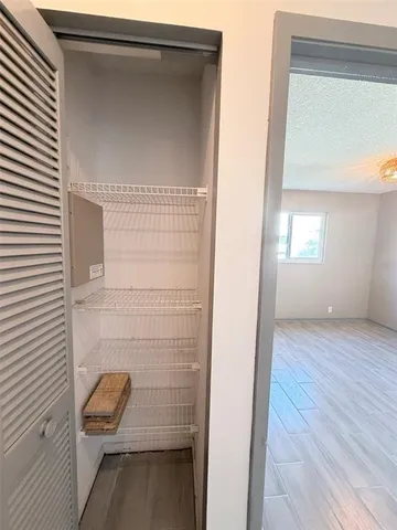 an empty room with windows and closet