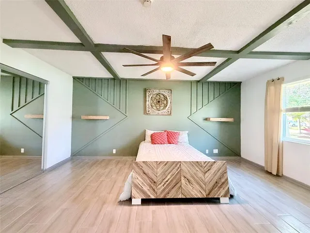 a living room with a couch and wooden floor