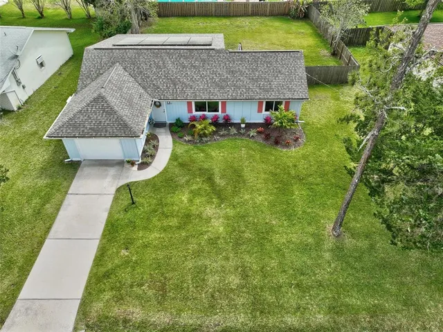 an aerial view of a house with swimming pool garden and patio
