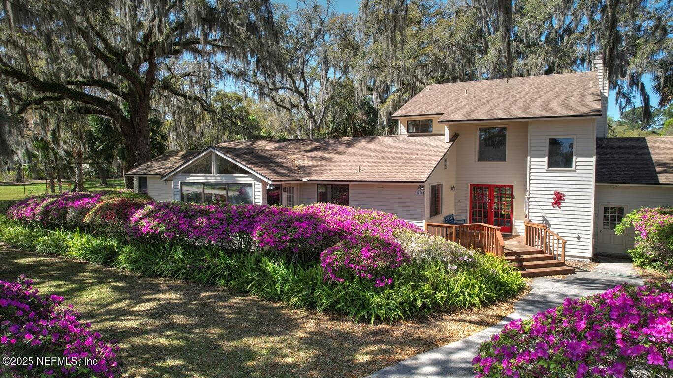a front view of a house with a yard and fountain