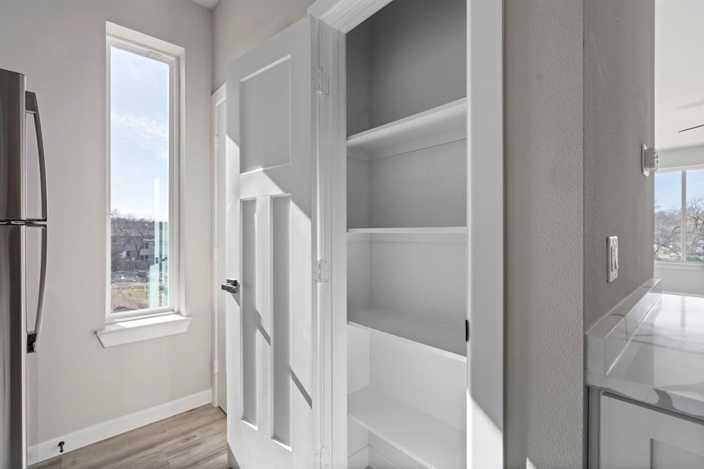 948 Corinth Street, Unit 5 Dallas, TX 75215 - Photo 13 of 28 Detailed view of freestanding refrigerator and wood finished floors