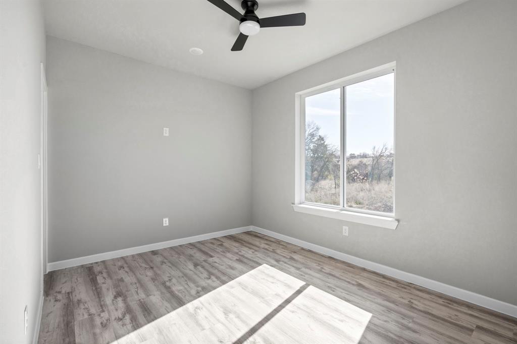 948 Corinth Street, Unit 5 Dallas, TX 75215 - Photo 20 of 28 Spare room with light wood finished floors and a ceiling fan