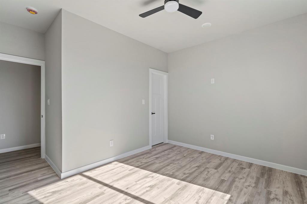 948 Corinth Street, Unit 5 Dallas, TX 75215 - Photo 22 of 28 Unfurnished bedroom featuring light wood-type flooring and a ceiling fan