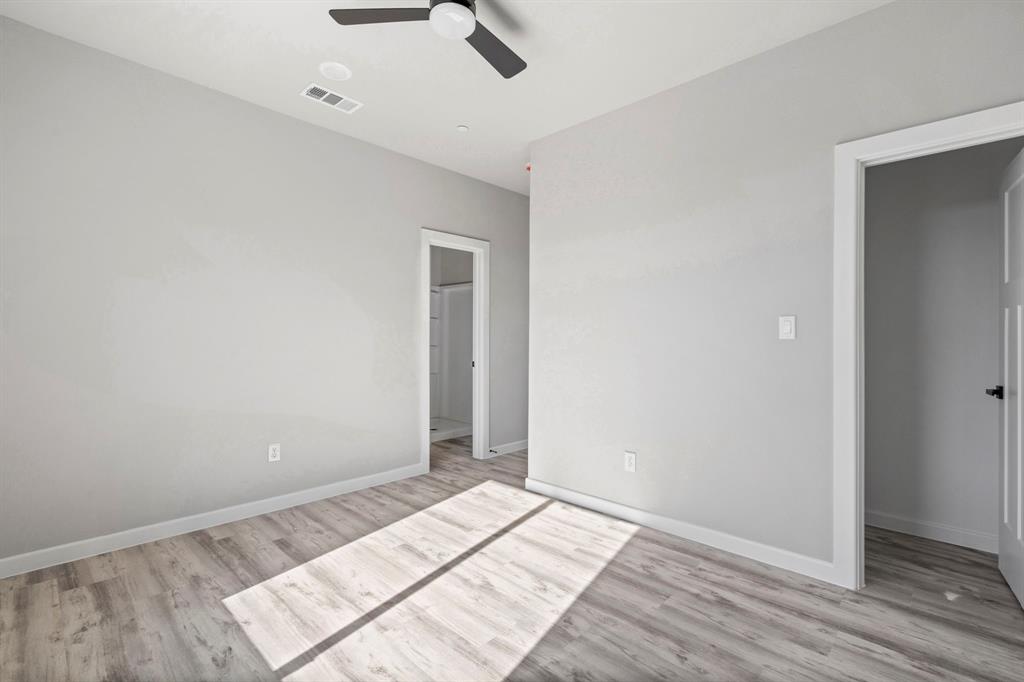 948 Corinth Street, Unit 5 Dallas, TX 75215 - Photo 23 of 28 Unfurnished bedroom featuring light wood-style flooring and ceiling fan