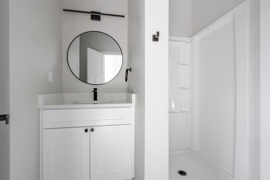 948 Corinth Street, Unit 5 Dallas, TX 75215 - Photo 25 of 28 Full bathroom featuring vanity and a stall shower