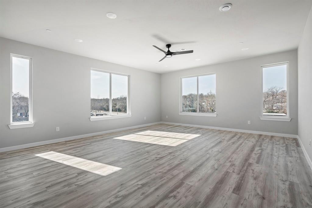 948 Corinth Street, Unit 5 Dallas, TX 75215 - Photo 8 of 28 Spare room featuring wood finished floors, a ceiling fan, and recessed lighting