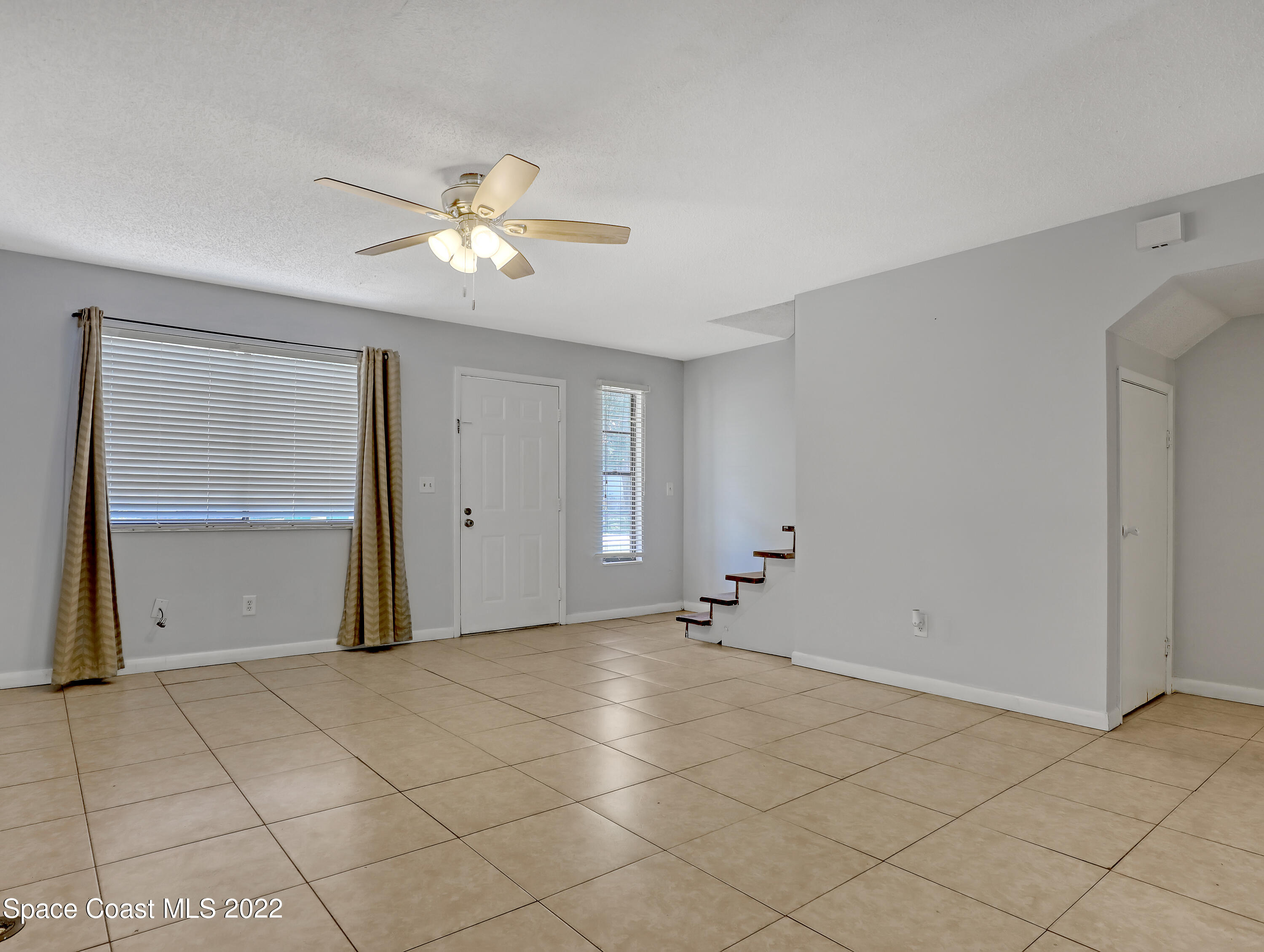 4016 Tree Ridge Lane Northeast Palm Bay, FL 32905 - Photo 3 of 20 Living Room looking at front door