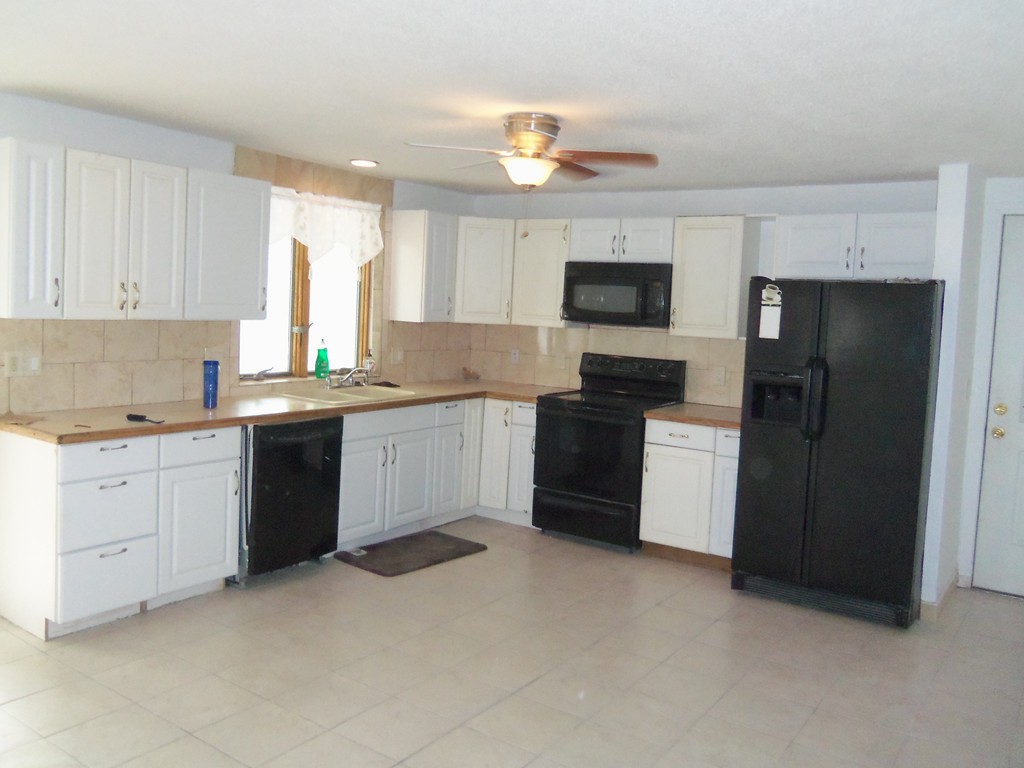 68 White Street Springfield, MA 01108 - Photo 4 of 5 a kitchen with a sink stove and refrigerator