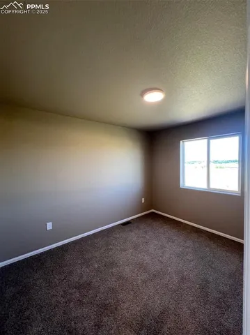 an empty room with a empty space and windows