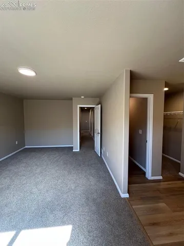 a view of hallway with wooden floor