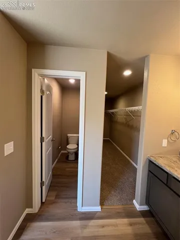 a bathroom with a toilet and a mirror