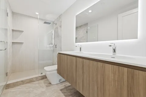 a bathroom with a sink toilet and shower