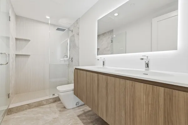a bathroom with a sink toilet and shower